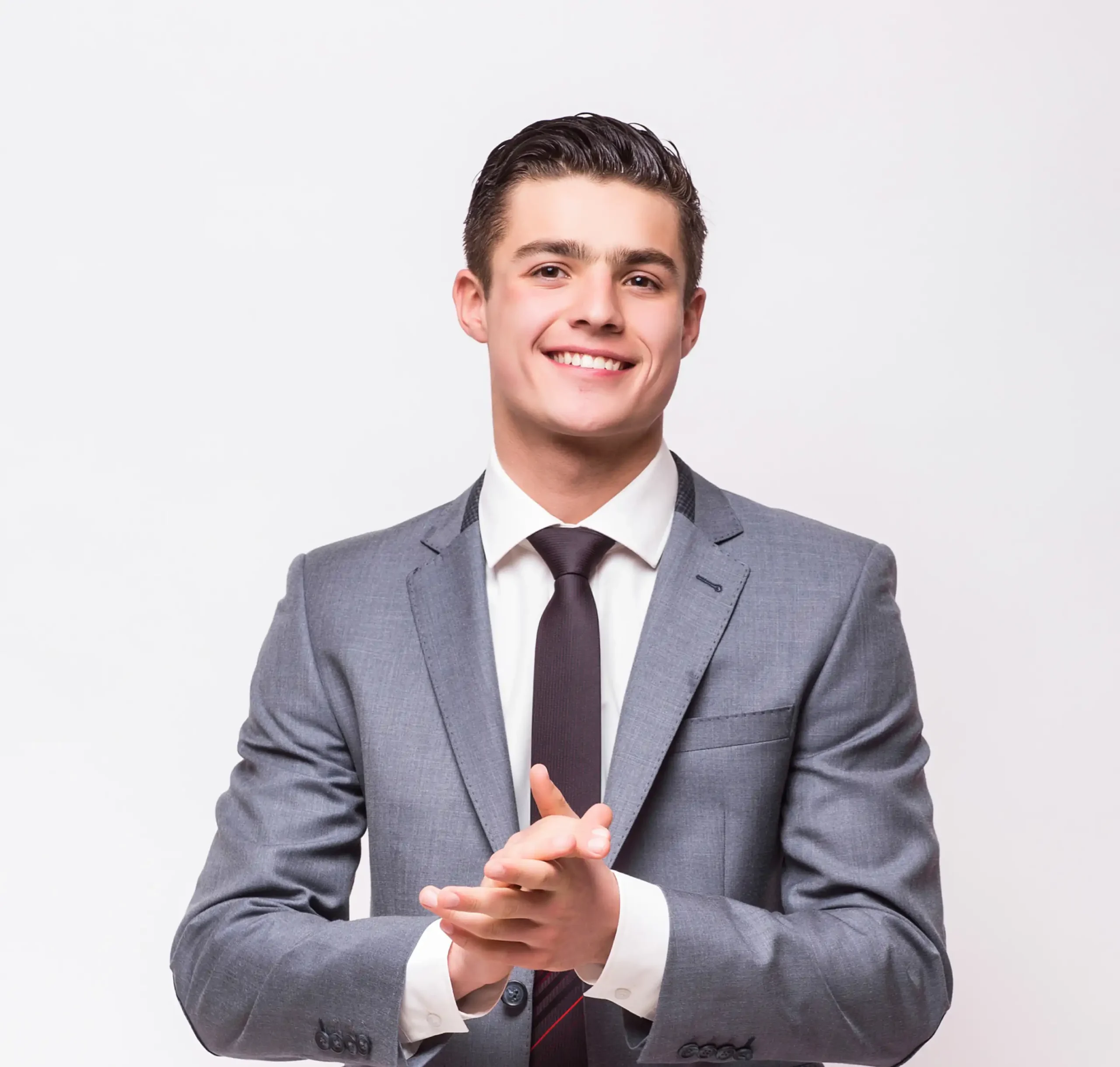 smiling-young-male-professional-standing-with-arms-crossed-while-making-eye-contact-against-isolated-background (2)